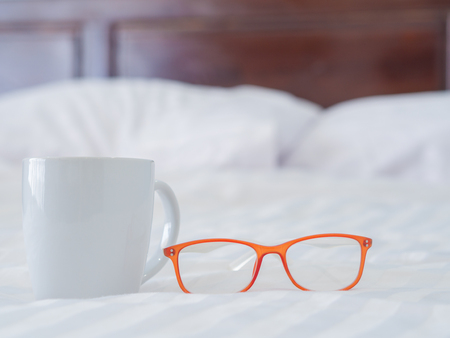 Glasses and White cup on the bed.の写真素材