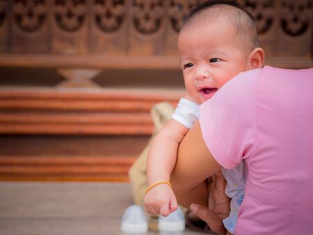 close up, Asian baby in mother's arms.の写真素材