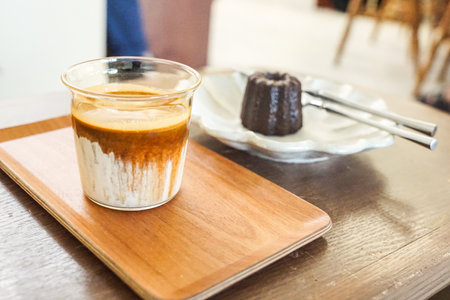 Coffee cup and cake on wooden table in coffee shop.の写真素材