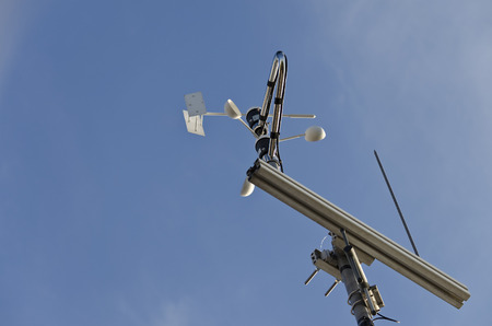 Anemometer and wind vane on blue sky