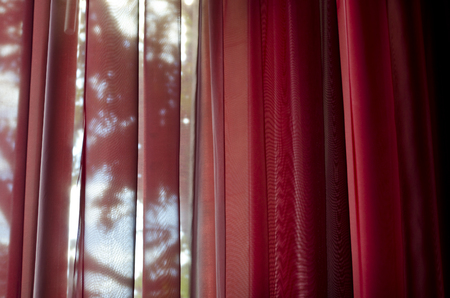 Curtain or drapes red backgroundの写真素材
