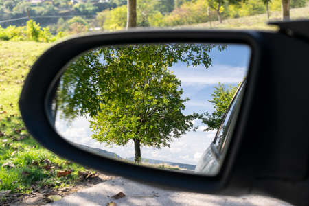 Looking in the side rear-view mirror in the day of dreamsの写真素材