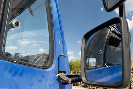 Retro side rear-view mirror on the road in the factory