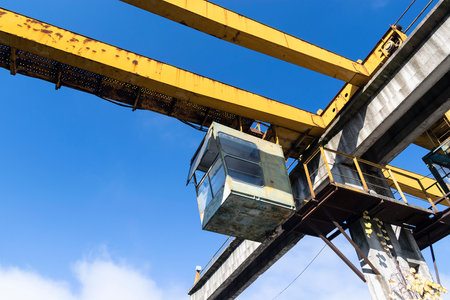 Big yellow lifting crane in the factoryの写真素材