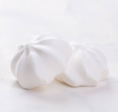 Closeup of meringue cookies on a white background, selective focusの写真素材