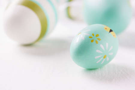 Colorful Easter eggs on a bright background, closeup, selective focus