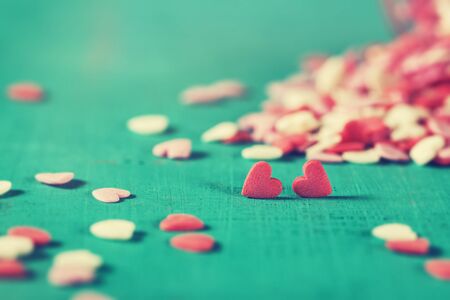 Couple of Sweet Hearts on a Wooden turquoise Background. Vintage Toning, horizontal. Love or...