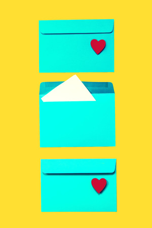 Beautiful Colorful Blue Envelops with Red Hearts on Yellow Background, Fashion Style, Flat Lay, Top...