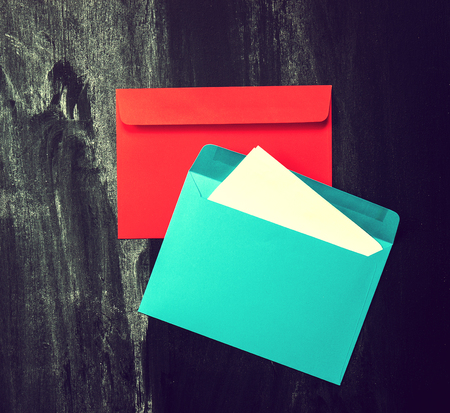 Colorful Envelops on Old Chalkboard Background. Message or Love Message Concept