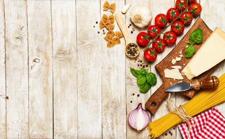 Italian food or ingredients background with fresh vegetables, pasta, cheese parmesan and spices. Top view, view from above. Copy space.の写真素材
