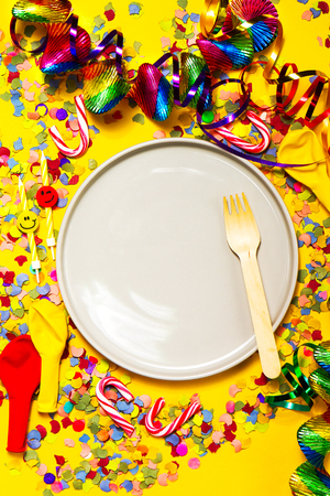 Party or Carnival background or Party concept with fun articles and party accessories, empty plate above. Top view. の写真素材