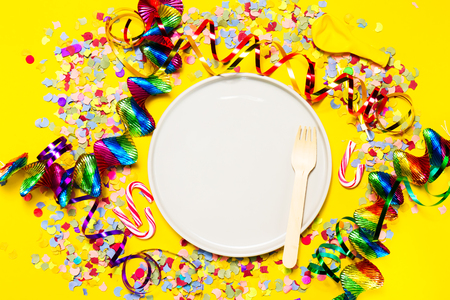 Party or Carnival background or Party concept with fun articles and party accessories, empty plate above. Top view. の写真素材
