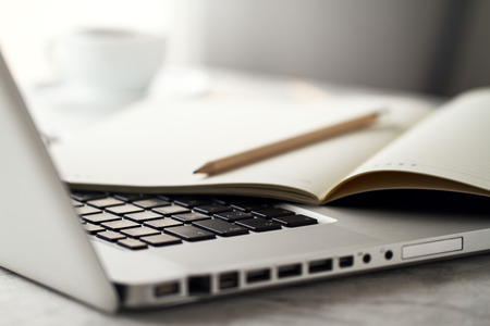 Closeup of Workspace with Modern Creative Laptop, Cup of Coffee and Pencils. Horizontal with Copy...