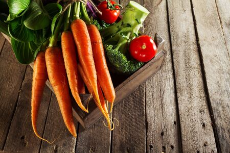Food Vegetable Colorful Background. Tasty Fresh Vegetables in Wooden Box on Wooden Table. Kitchen Background. Copy Space.の写真素材