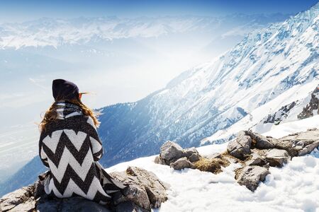 Girl Hipster Looking to the Mountain Landscape. Traveling or Vacation Concept. Alps. Austria.の写真素材