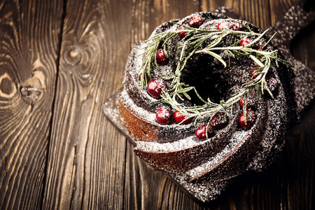 From above view of chocolate caked topped with sugar powder and berries for delicious holiday. の写真素材