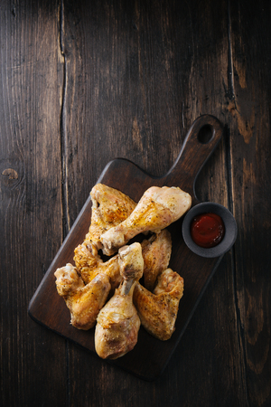 From above fried chicken pieces with sauce on chopping board. の写真素材