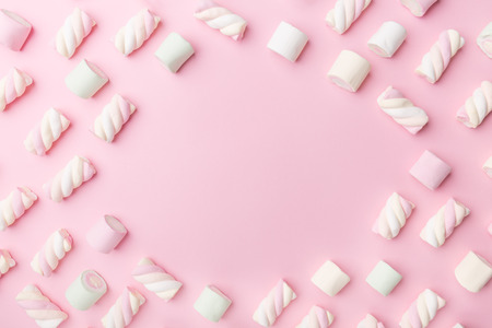 Different pastel color marshmallows on pink pastel background with copy space. Top View. Conceptual Food Trend Flat Layの写真素材