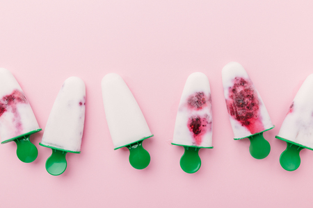 Homemade ice cream from coconut milk and berries on pink background. Food Conceptの写真素材