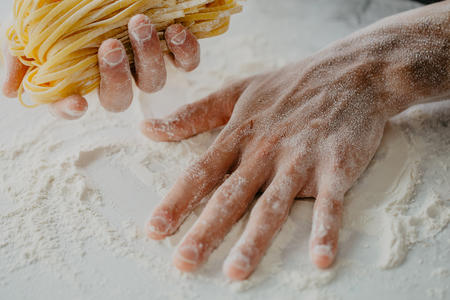 Closeup of process of making cooking homemade pasta. Chef make fresh italian traditional pastaの写真素材