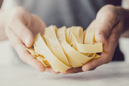 Closeup of process of making cooking homemade pasta. Chef make fresh italian traditional pastaの写真素材
