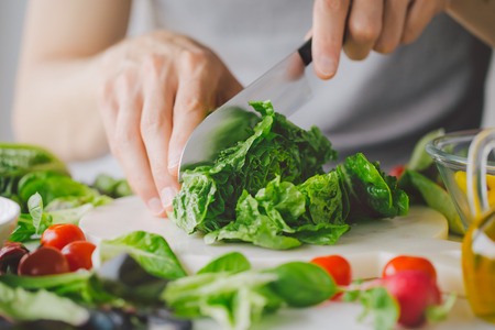 Man preparing cooking fresh detox healthy salad on table. Closeupの写真素材