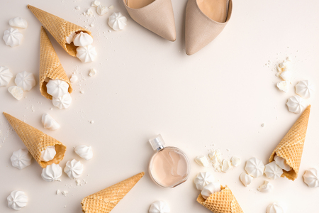 Summer spring female tender background. View from Above with peony, shoes, ice cream waffle cones and merengue on beige. Top View with Copy Spaceの写真素材