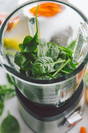 Cooking healthy detox smoothie with fresh fruits and green spinach. Lifestyle detox conceptの写真素材