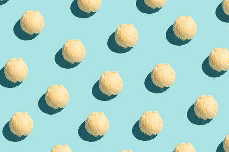 Ice cream scoops in food pattern on blue background. Food fashion modern food concept. View from...