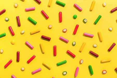 Flat Lay of Tasty Colorful Sweets on Yellow Background. Party Happy Birthday Concept. Sweet Patternの写真素材