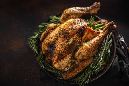 Closeup of tasty baked poultry turkey with rosemary. Thanksgiving or Christmas food.の写真素材