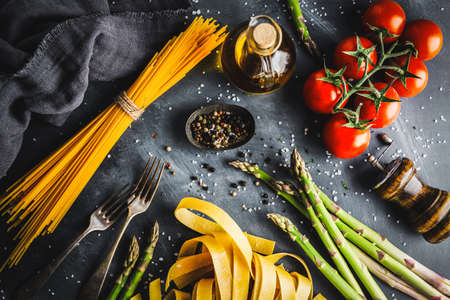 Italian food background with pasta and ingredients for cooking. View from above. Cooking concept