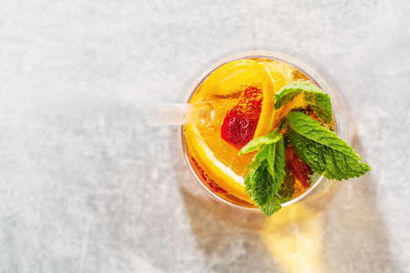 Tasty fresh drink with orange strawberry and mint served in glass. Closeupの写真素材