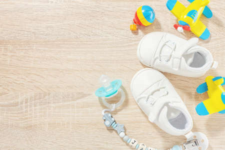 Baby accessories for healthcare, playing and feeding on table. Flat lay. Baby or children concept.