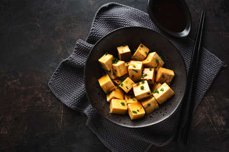 Tasty appetizing healthy lunch to go served in boxes with fruits and spices on blackboard. Top viewの写真素材