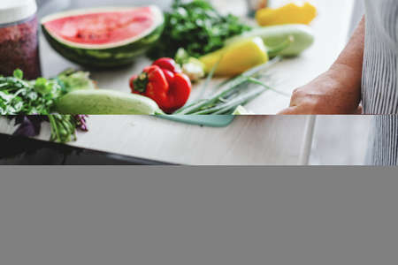 Woman cooking vegetables in the kitchen. Cuting eggplant. Home cooking conceptの写真素材