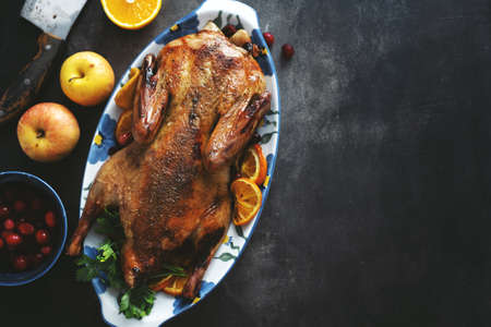 Baked duck with vegetables served on table. Top View.の写真素材