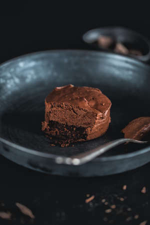 Chocolate muffin cheesecake on dark plate with fork. Closeupの写真素材