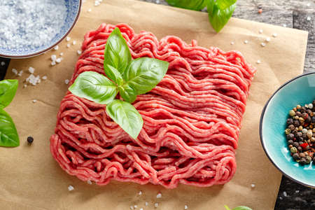 Minced meat with spices on paper on table. Closeupの写真素材