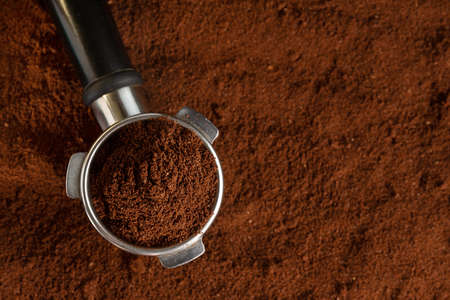 Coffee background. Coffee automatic from machine with ground coffee on coffee background. Closeup.の写真素材