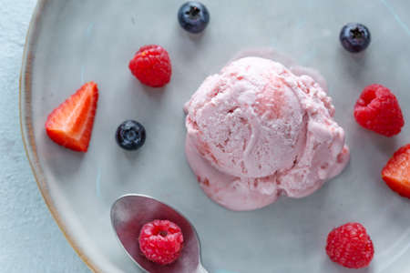 Fruity strawberry Ice cream scoop served on plate with fruits. Top view.の写真素材