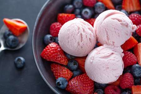 Fruity strawberry Ice cream scoops served on plate with fruits. Top view.の写真素材