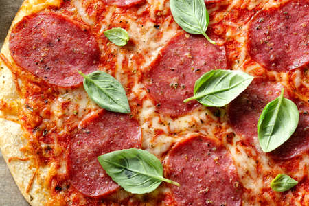 Closeup of tasty appetizing salami pizza with cheese and spices.の写真素材