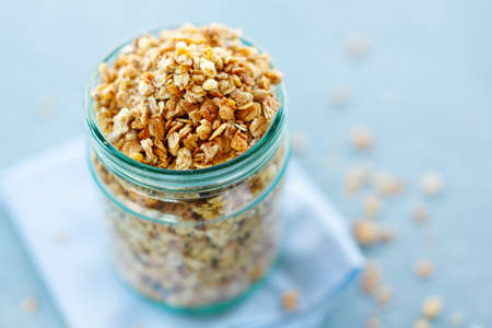 Tasty homemade fruity muesli granola in glas on bright background. Closeupの写真素材