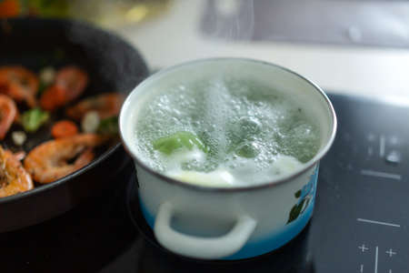 Steaming boiling pot on electric oven in the kitchen.の写真素材