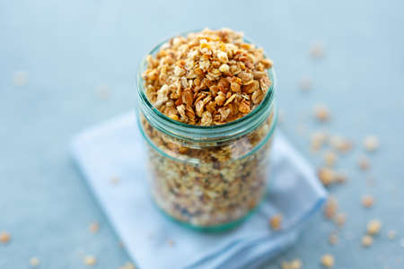 Tasty homemade fruity muesli granola in glas on bright background. Closeupの写真素材