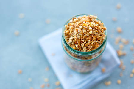 Tasty homemade fruity muesli granola in glas on bright background. Closeupの写真素材