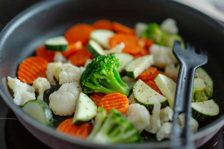Fresh vegetables cooking on pan at home kitchen. Closeup.の写真素材