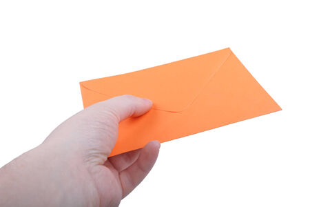 Hand with orange envelope on white background.の写真素材