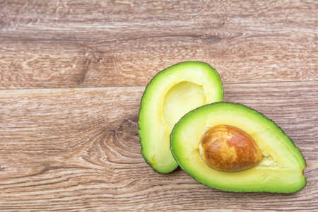 Cut avocado on a wooden backgroundの写真素材